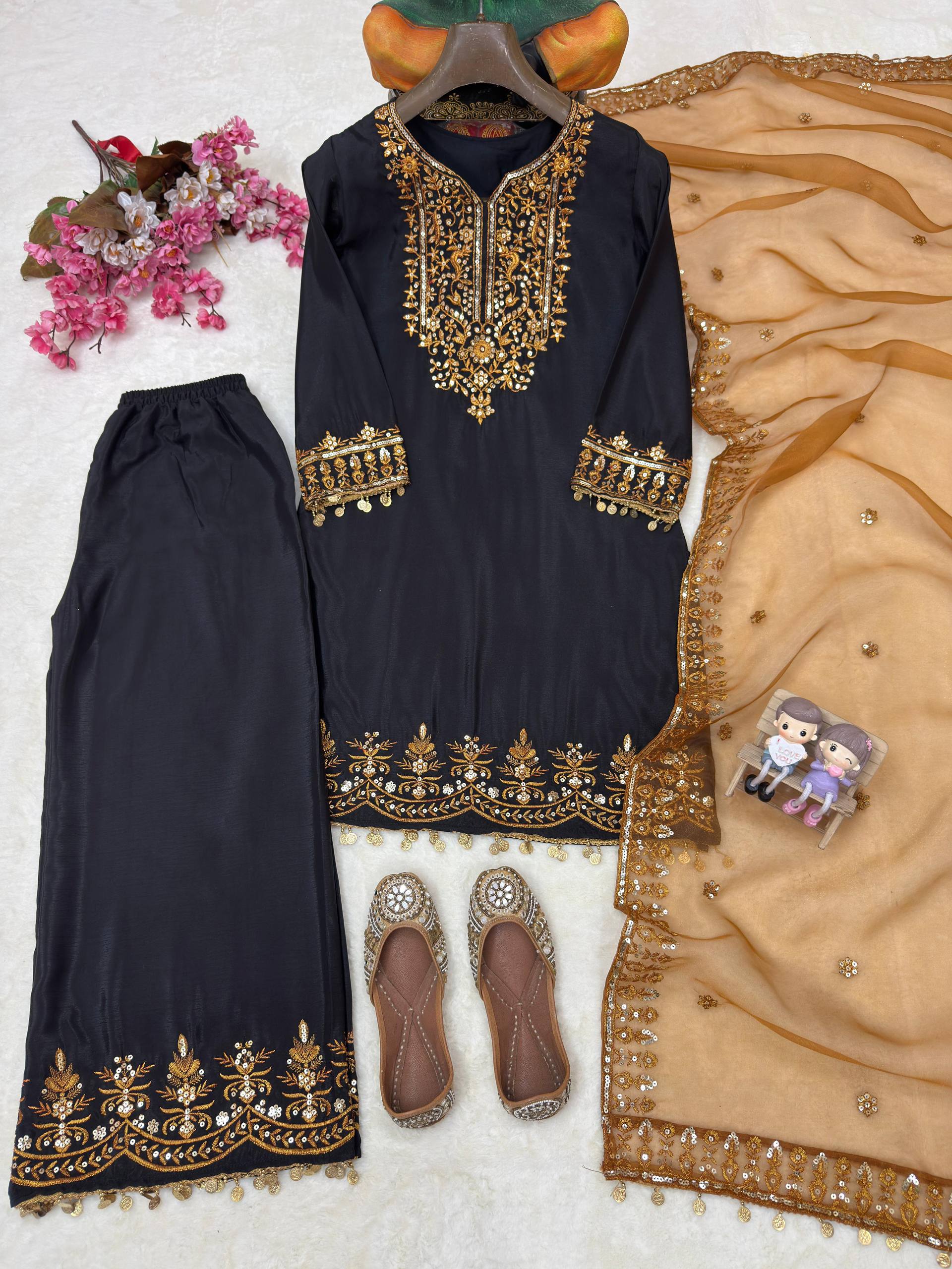 Black embroidered outfit with gold details, pants, shoes, and a dupatta on a white background.